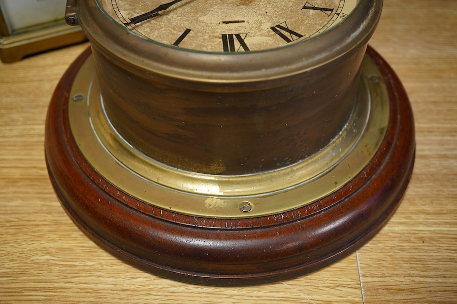 A brass bulk head timepiece and a late 19th century brass cased carriage clock, the dial inscribed Mallory Bath, made in Paris, with key